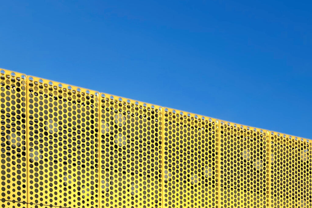 Yellow wall structure and blue sky in front Shopping centre Redi in Kalasatama, Helsinki, Finland