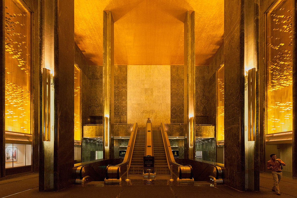 A man walking at the lobby at 45 Rockefeller Plaza in New York City, USA