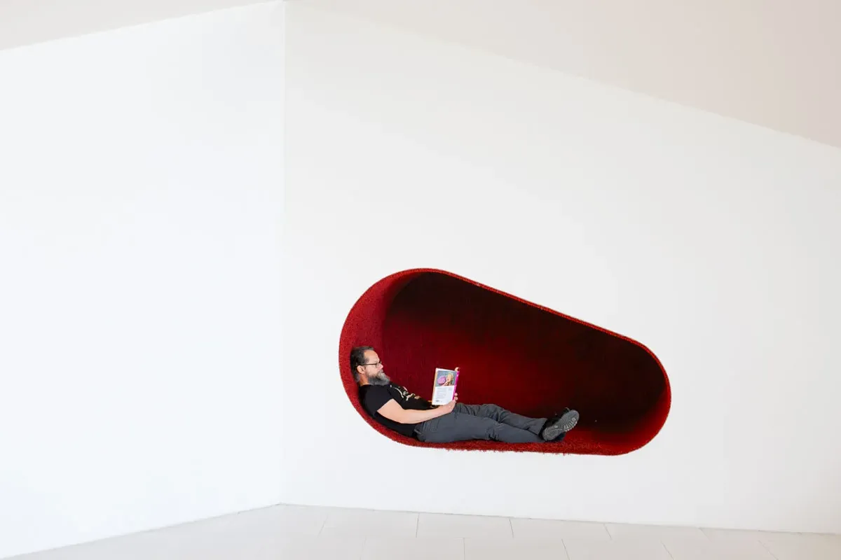 A man reading a book in Seinäjoki City Library Apila by JKMM Architects in Seinäjoki, Finland